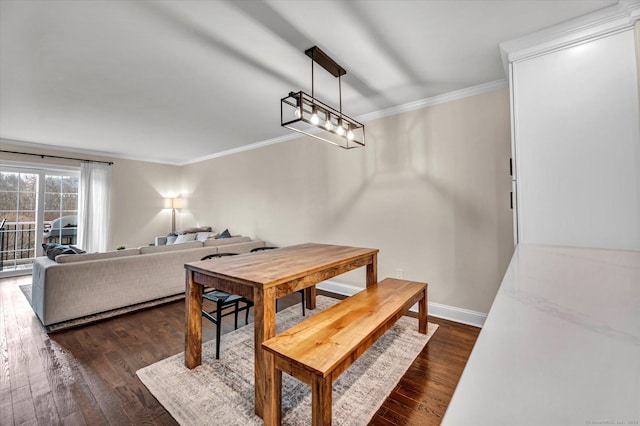 dining space with dark hardwood / wood-style flooring and ornamental molding