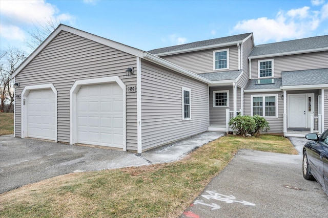 view of front of home featuring a garage and a front lawn