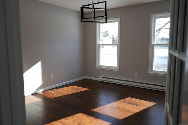 unfurnished dining area with a wealth of natural light, a baseboard heating unit, and dark hardwood / wood-style flooring