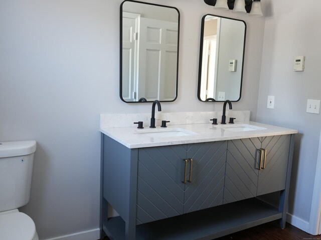 bathroom featuring toilet and vanity