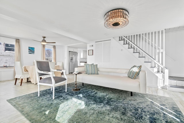 living room featuring ceiling fan and wood-type flooring