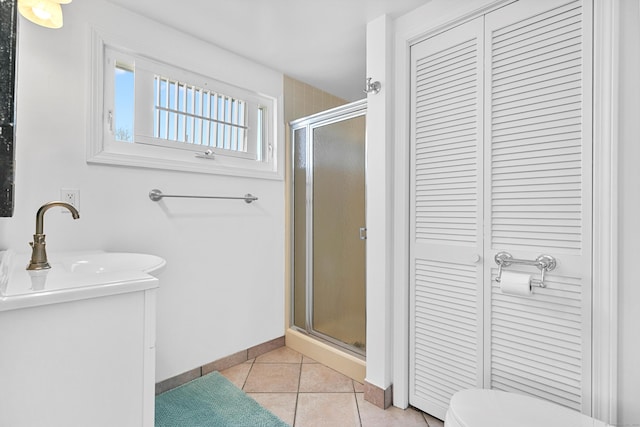 bathroom featuring walk in shower, tile patterned flooring, sink, and toilet