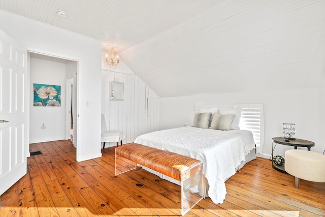 bedroom featuring lofted ceiling, light wood-type flooring, a chandelier, and wooden ceiling