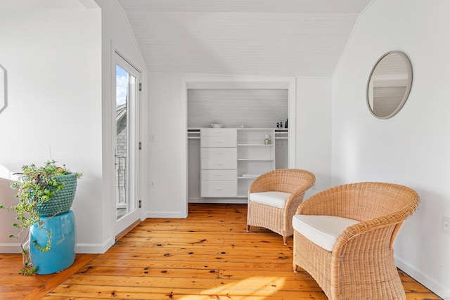 sitting room featuring light hardwood / wood-style flooring and vaulted ceiling