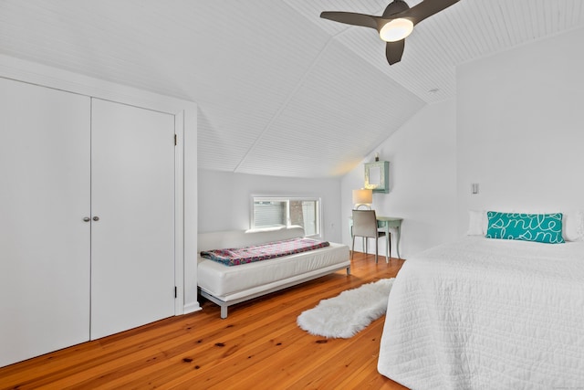 bedroom featuring vaulted ceiling, ceiling fan, a closet, and hardwood / wood-style floors