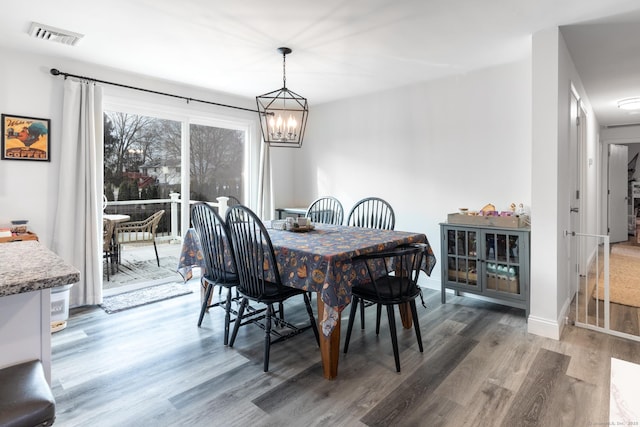 dining room with a chandelier and hardwood / wood-style flooring