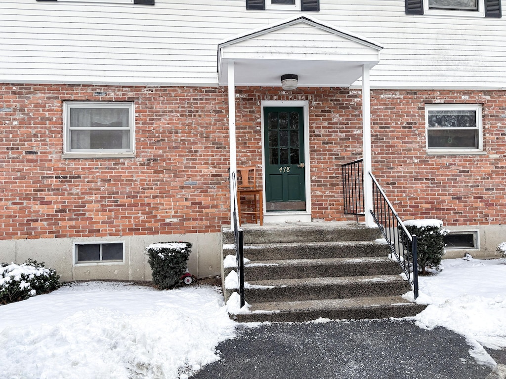 view of snow covered property entrance