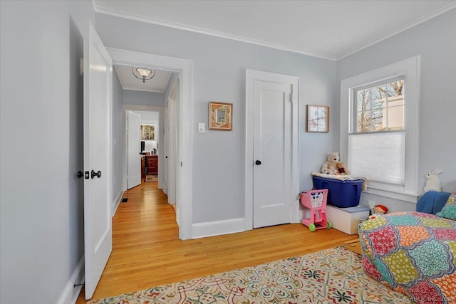 bedroom featuring crown molding and light hardwood / wood-style floors