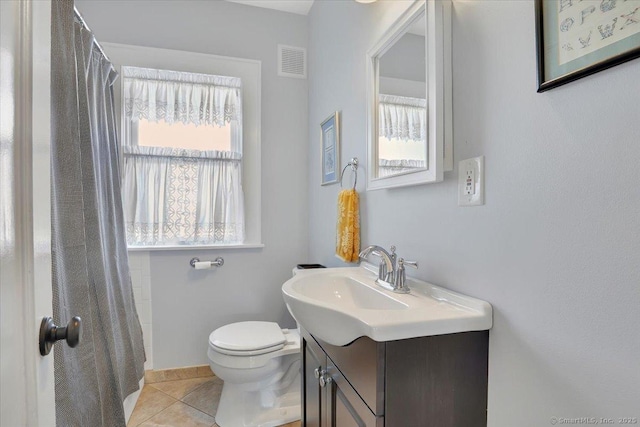 bathroom with vanity, tile patterned floors, and toilet