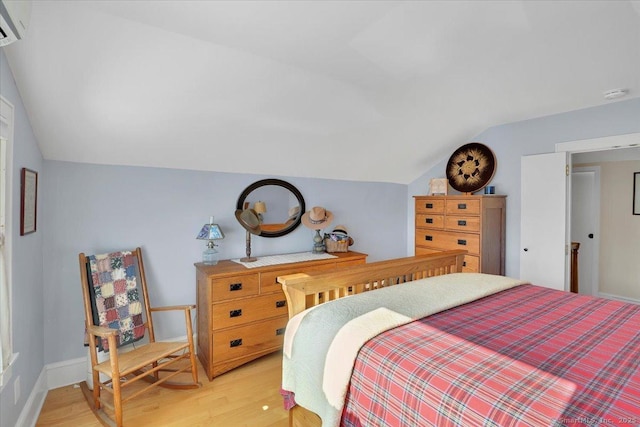 bedroom featuring lofted ceiling and light wood-type flooring