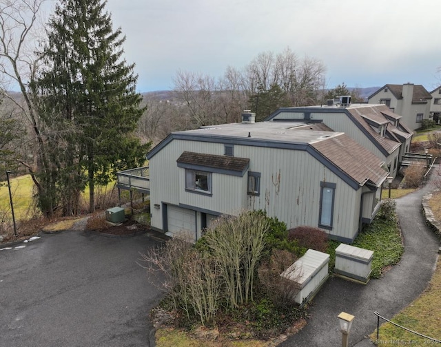 rear view of property featuring a garage