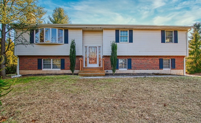 raised ranch featuring a front lawn