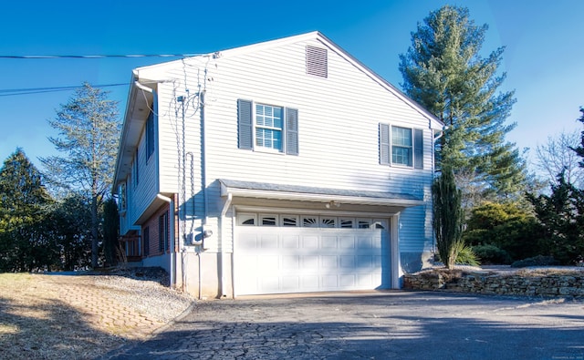 view of property exterior with a garage