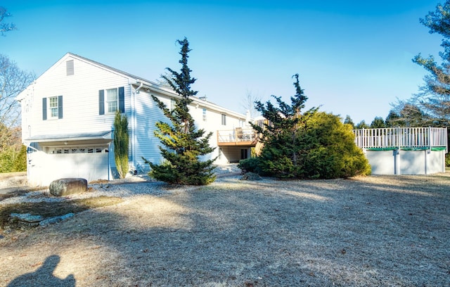 view of front of property with a garage and a wooden deck