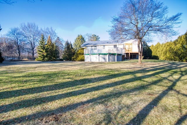 view of yard with a pool side deck