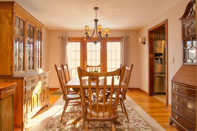 dining room featuring a notable chandelier and light hardwood / wood-style floors