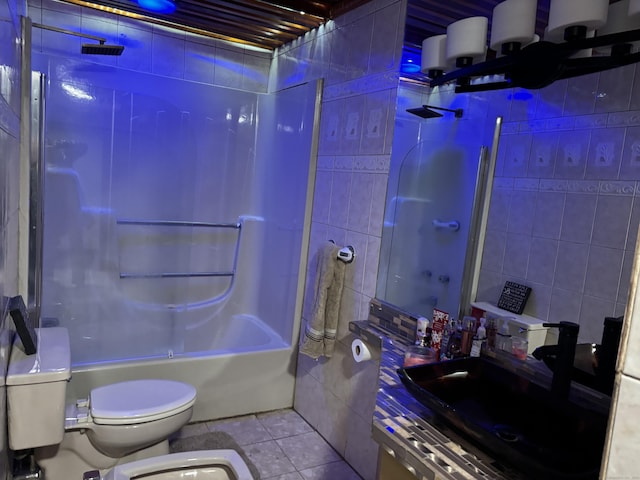 full bathroom featuring tile patterned floors, toilet, tile walls, shower / tub combination, and vanity