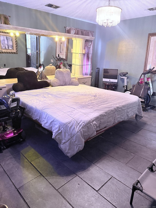 bedroom with a textured ceiling and a notable chandelier