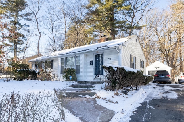 view of front of house featuring a garage and an outdoor structure