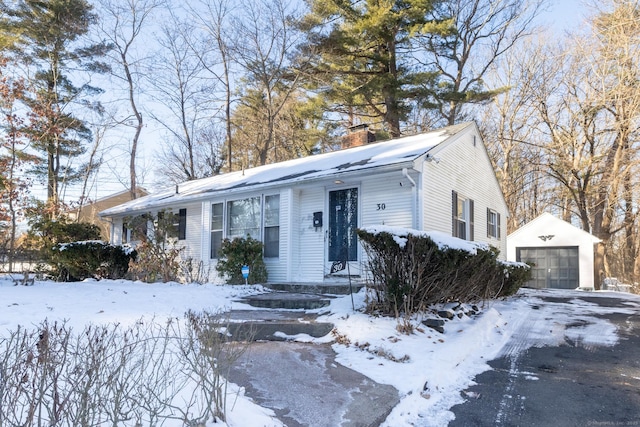 view of front of home with a garage and an outdoor structure