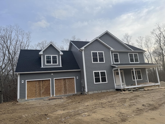 view of front of house featuring a garage and a porch