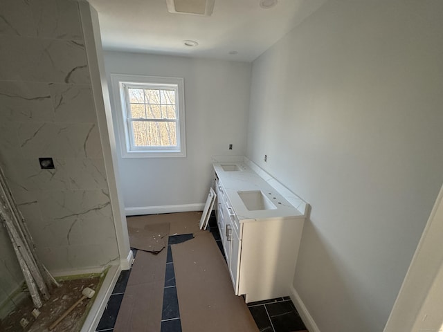 laundry room featuring baseboards