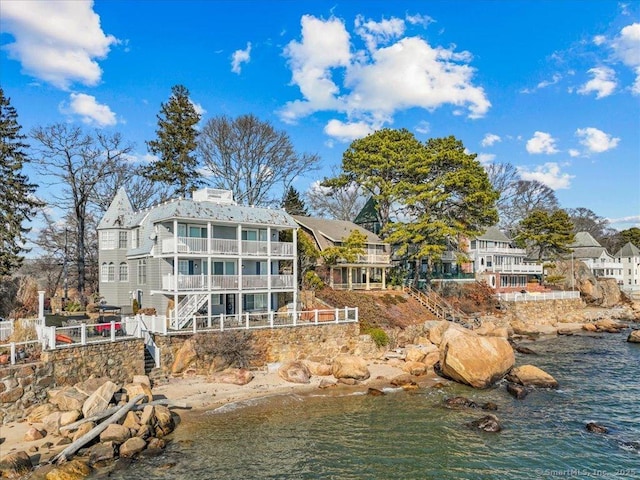 back of house featuring a water view