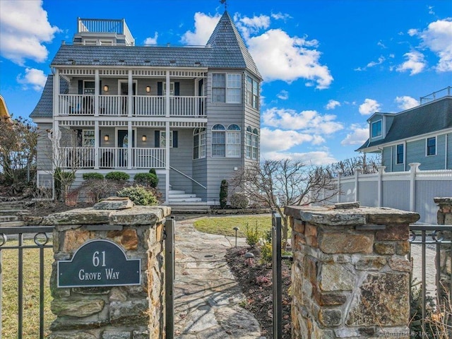 view of front of house featuring a balcony and a porch