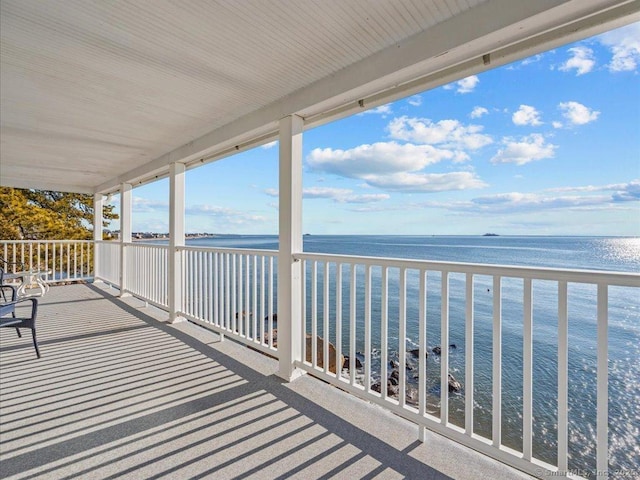 balcony featuring a water view and a beach view