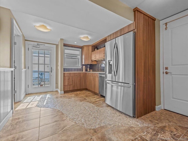 kitchen with decorative backsplash, sink, and stainless steel appliances