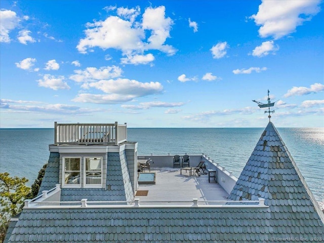 view of dock featuring a balcony and a water view