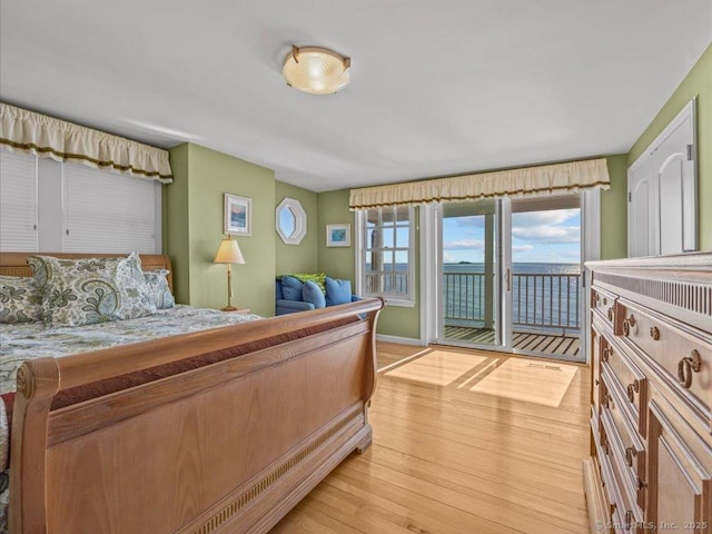 bedroom with access to exterior and light hardwood / wood-style floors