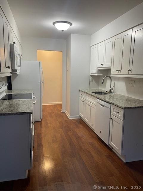 kitchen featuring sink, white dishwasher, white cabinetry, light stone countertops, and dark hardwood / wood-style flooring