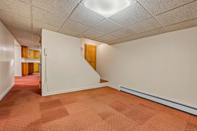 basement with carpet floors and a baseboard heating unit