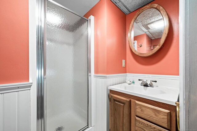 bathroom with an enclosed shower and vanity