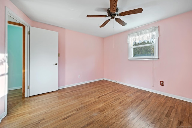 empty room with light hardwood / wood-style floors and ceiling fan