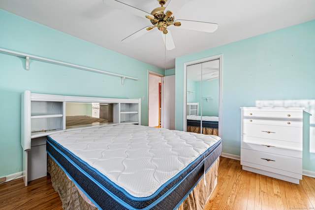 bedroom featuring light wood-type flooring, ceiling fan, and a closet