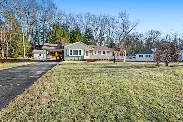 ranch-style home featuring a gazebo, a front lawn, and a carport