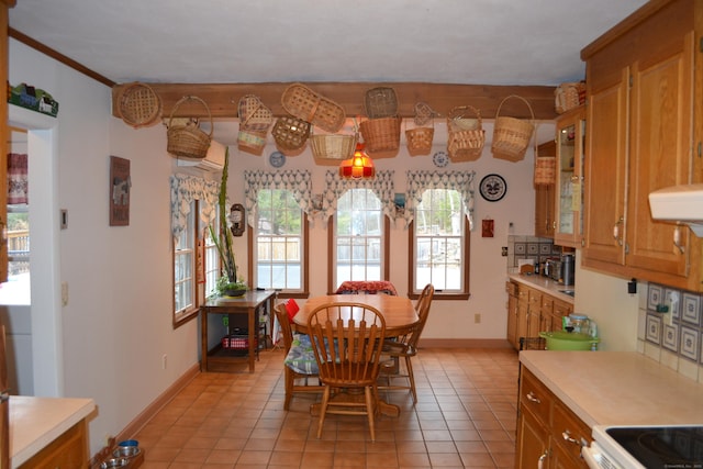 tiled dining room featuring ornamental molding