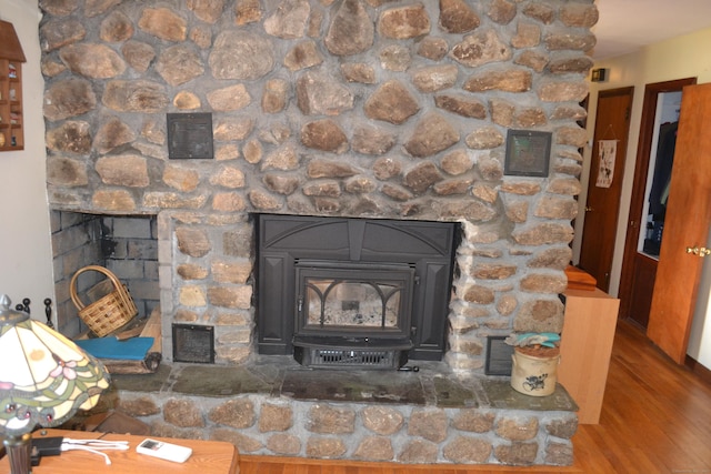 room details with wood-type flooring and a wood stove