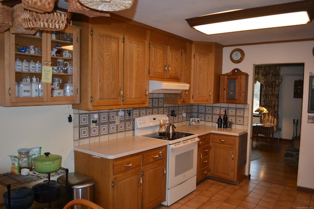 kitchen with tasteful backsplash, ornamental molding, light tile patterned flooring, and white range with electric stovetop