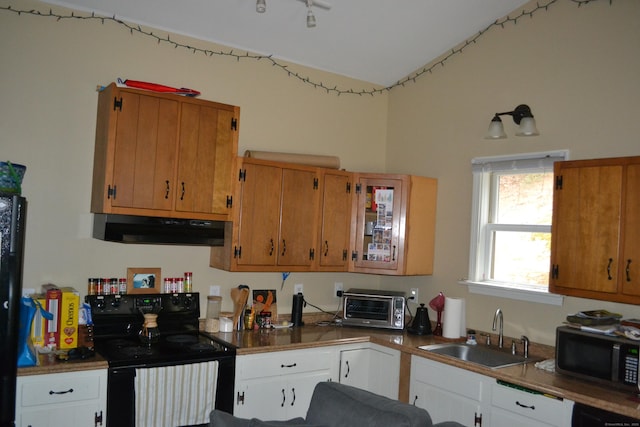 kitchen with sink, white cabinets, and black appliances