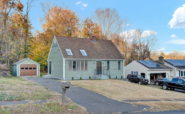 view of front facade featuring an outbuilding and a garage