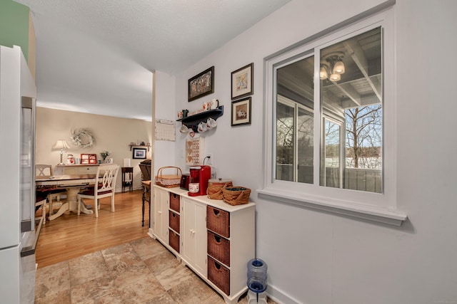 kitchen featuring high end fridge and a textured ceiling