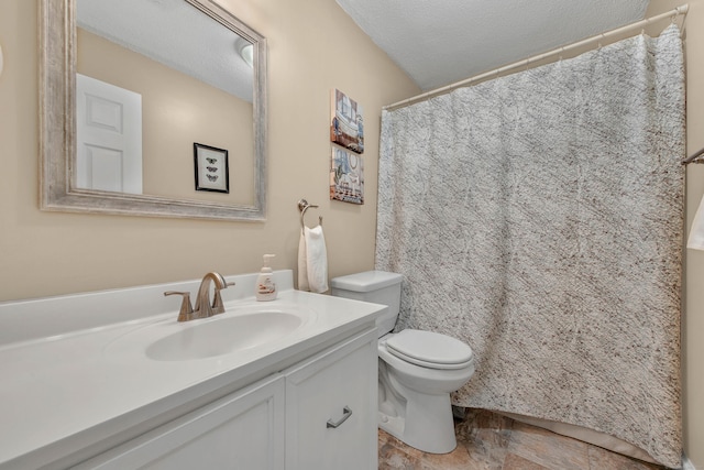 bathroom with vanity, a textured ceiling, and toilet