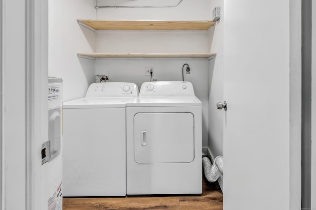 washroom featuring washing machine and dryer and hardwood / wood-style flooring