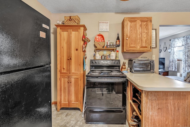 kitchen featuring a textured ceiling and black appliances