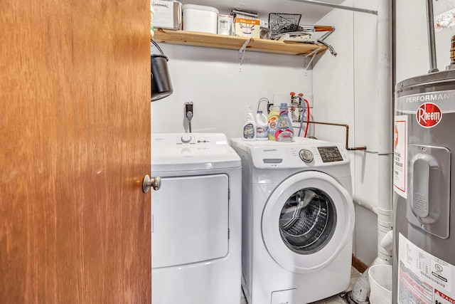 washroom featuring electric water heater and washing machine and dryer