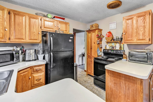 kitchen with a textured ceiling, sink, kitchen peninsula, and black appliances