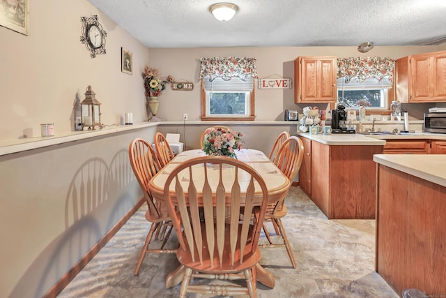 dining space featuring a textured ceiling and sink